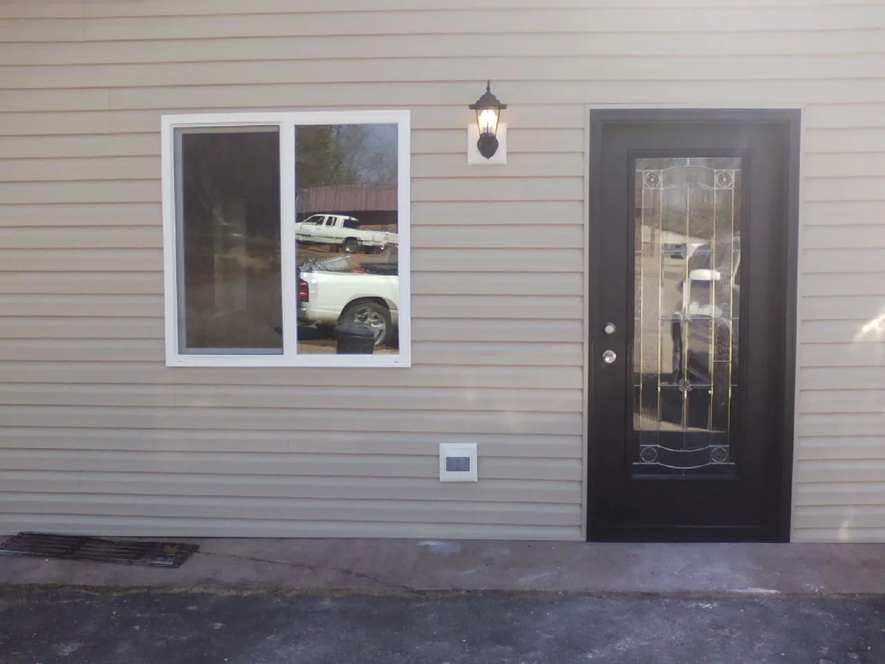New siding, window and entry door on the side of an addition in Collinsville